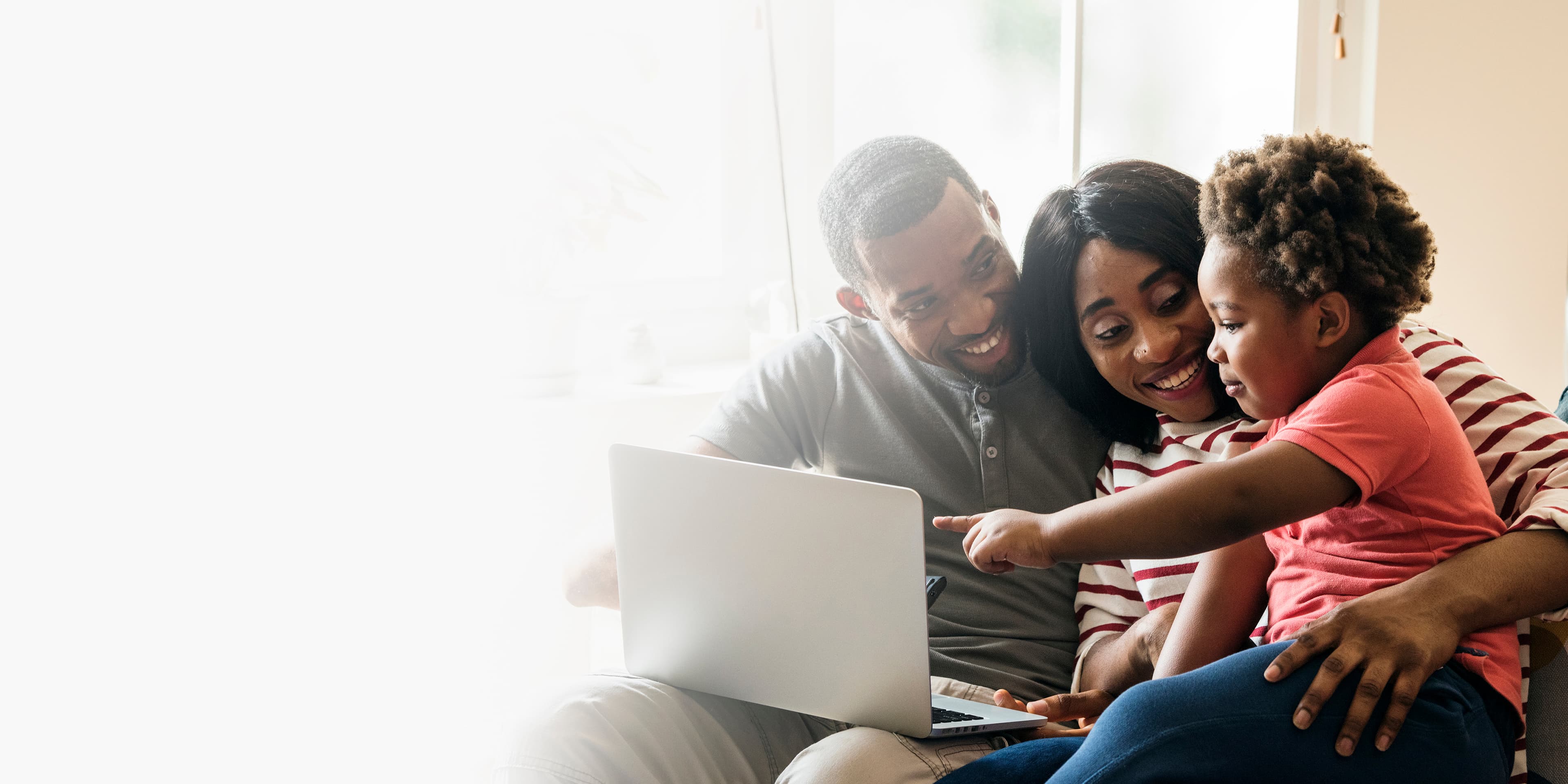 Parent and child using laptop together